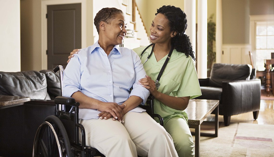 Nurse with woman in wheelchair at home Nurse with woman in wheelchair at home